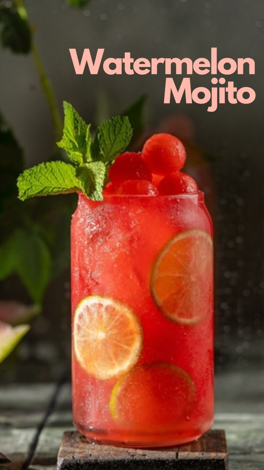 Red watermelon mojito with lime slices and fresh mint over ice